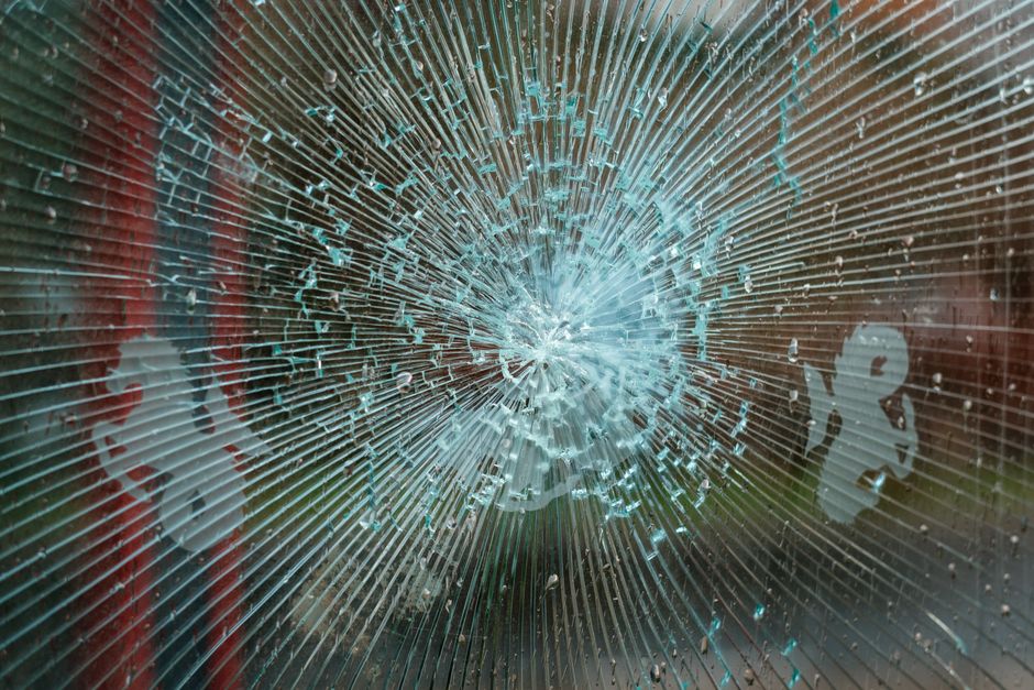 Severely cracked car window requiring full windshield replacement