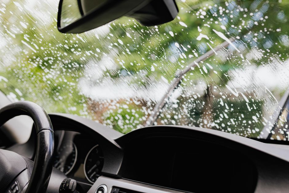 Technician cleaning and finalizing a complete car window replacement